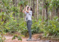 Beginner bird watching in Thailand using binoculars in tropical forest